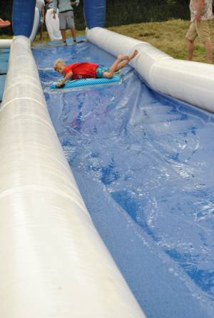 Ilminster Town FC fun day Part 3 – July 9, 2016: A giant water slide was the star attraction at a family fun day held to celebrate Ilminster Town Football Club’s new Archie Gooch Pavilion headquarters in Britten’s Field. Photo 13