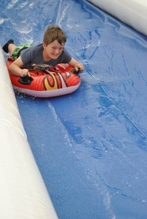 Ilminster Town FC fun day Part 3 – July 9, 2016: A giant water slide was the star attraction at a family fun day held to celebrate Ilminster Town Football Club’s new Archie Gooch Pavilion headquarters in Britten’s Field. Photo 16