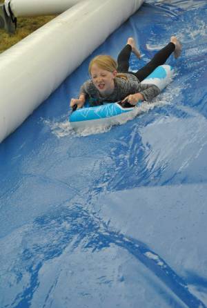 Ilminster Town FC fun day Part 3 – July 9, 2016: A giant water slide was the star attraction at a family fun day held to celebrate Ilminster Town Football Club’s new Archie Gooch Pavilion headquarters in Britten’s Field. Photo 1