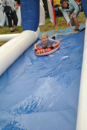 Ilminster Town FC fun day Part 3 – July 9, 2016: A giant water slide was the star attraction at a family fun day held to celebrate Ilminster Town Football Club’s new Archie Gooch Pavilion headquarters in Britten’s Field. Photo 2