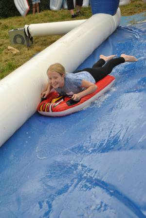 Ilminster Town FC fun day Part 3 – July 9, 2016: A giant water slide was the star attraction at a family fun day held to celebrate Ilminster Town Football Club’s new Archie Gooch Pavilion headquarters in Britten’s Field. Photo 3