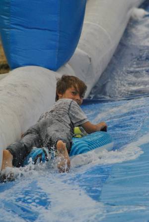 Ilminster Town FC fun day Part 4 – July 9, 2016: A giant water slide was the star attraction at a family fun day held to celebrate Ilminster Town Football Club’s new Archie Gooch Pavilion headquarters in Britten’s Field. Photo 25