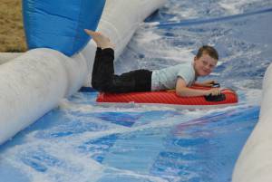 Ilminster Town FC fun day Part 5 – July 9, 2016: A giant water slide was the star attraction at a family fun day held to celebrate Ilminster Town Football Club’s new Archie Gooch Pavilion headquarters in Britten’s Field. Photo 2