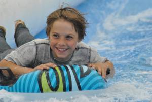Ilminster Town FC fun day Part 6 – July 9, 2016: A giant water slide was the star attraction at a family fun day held to celebrate Ilminster Town Football Club’s new Archie Gooch Pavilion headquarters in Britten’s Field. Photo 25