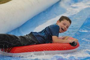 Ilminster Town FC fun day Part 7 – July 9, 2016: A giant water slide was the star attraction at a family fun day held to celebrate Ilminster Town Football Club’s new Archie Gooch Pavilion headquarters in Britten’s Field. Photo 10