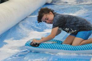Ilminster Town FC fun day Part 7 – July 9, 2016: A giant water slide was the star attraction at a family fun day held to celebrate Ilminster Town Football Club’s new Archie Gooch Pavilion headquarters in Britten’s Field. Photo 16