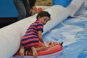 Ilminster Town FC fun day Part 7 – July 9, 2016: A giant water slide was the star attraction at a family fun day held to celebrate Ilminster Town Football Club’s new Archie Gooch Pavilion headquarters in Britten’s Field. Photo 17