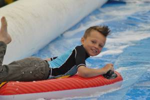 Ilminster Town FC fun day Part 7 – July 9, 2016: A giant water slide was the star attraction at a family fun day held to celebrate Ilminster Town Football Club’s new Archie Gooch Pavilion headquarters in Britten’s Field. Photo 26