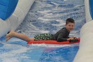 Ilminster Town FC fun day Part 7 – July 9, 2016: A giant water slide was the star attraction at a family fun day held to celebrate Ilminster Town Football Club’s new Archie Gooch Pavilion headquarters in Britten’s Field. Photo 2