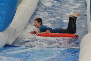 Ilminster Town FC fun day Part 7 – July 9, 2016: A giant water slide was the star attraction at a family fun day held to celebrate Ilminster Town Football Club’s new Archie Gooch Pavilion headquarters in Britten’s Field. Photo 8