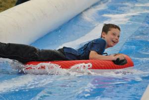 Ilminster Town FC fun day Part 7 – July 9, 2016: A giant water slide was the star attraction at a family fun day held to celebrate Ilminster Town Football Club’s new Archie Gooch Pavilion headquarters in Britten’s Field. Photo 9