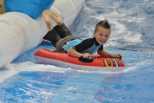 Ilminster Town FC fun day Part 8 – July 9, 2016: A giant water slide was the star attraction at a family fun day held to celebrate Ilminster Town Football Club’s new Archie Gooch Pavilion headquarters in Britten’s Field. Photo 18