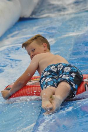 Ilminster Town FC fun day Part 8 – July 9, 2016: A giant water slide was the star attraction at a family fun day held to celebrate Ilminster Town Football Club’s new Archie Gooch Pavilion headquarters in Britten’s Field. Photo 27