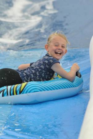 Ilminster Town FC fun day Part 12 – July 9, 2016: A giant water slide was the star attraction at a family fun day held to celebrate Ilminster Town Football Club’s new Archie Gooch Pavilion headquarters in Britten’s Field. Photo 12