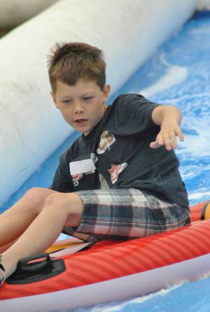 Ilminster Town FC fun day Part 12 – July 9, 2016: A giant water slide was the star attraction at a family fun day held to celebrate Ilminster Town Football Club’s new Archie Gooch Pavilion headquarters in Britten’s Field. Photo 1