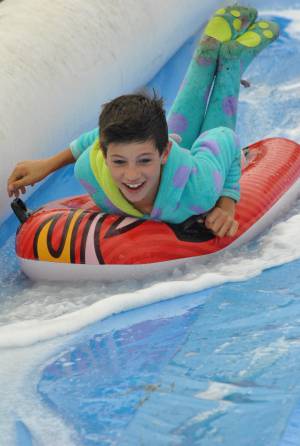 Ilminster Town FC fun day Part 12 – July 9, 2016: A giant water slide was the star attraction at a family fun day held to celebrate Ilminster Town Football Club’s new Archie Gooch Pavilion headquarters in Britten’s Field. Photo 24