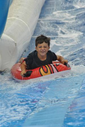 Ilminster Town FC fun day Part 14 – July 9, 2016: A giant water slide was the star attraction at a family fun day held to celebrate Ilminster Town Football Club’s new Archie Gooch Pavilion headquarters in Britten’s Field. Photo 19