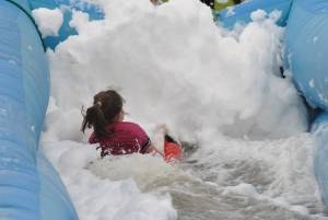 Ilminster Town FC fun day Part 15 – July 9, 2016: A giant water slide was the star attraction at a family fun day held to celebrate Ilminster Town Football Club’s new Archie Gooch Pavilion headquarters in Britten’s Field. Photo 25