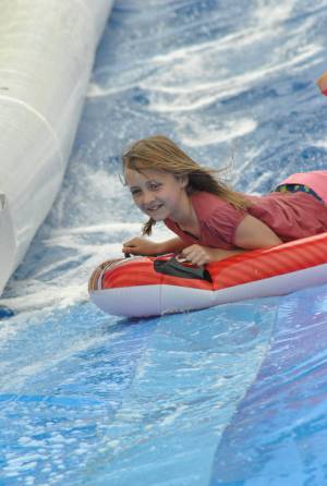 Ilminster Town FC fun day Part 16 – July 9, 2016: A giant water slide was the star attraction at a family fun day held to celebrate Ilminster Town Football Club’s new Archie Gooch Pavilion headquarters in Britten’s Field. Photo 1