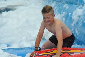 Ilminster Town FC fun day Part 17 – July 9, 2016: A giant water slide was the star attraction at a family fun day held to celebrate Ilminster Town Football Club’s new Archie Gooch Pavilion headquarters in Britten’s Field. Photo 16