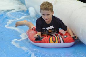 Ilminster Town FC fun day Part 17 – July 9, 2016: A giant water slide was the star attraction at a family fun day held to celebrate Ilminster Town Football Club’s new Archie Gooch Pavilion headquarters in Britten’s Field. Photo 2