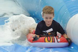 Ilminster Town FC fun day Part 17 – July 9, 2016: A giant water slide was the star attraction at a family fun day held to celebrate Ilminster Town Football Club’s new Archie Gooch Pavilion headquarters in Britten’s Field. Photo 3
