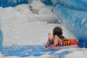 Ilminster Town FC fun day Part 18 – July 9, 2016: A giant water slide was the star attraction at a family fun day held to celebrate Ilminster Town Football Club’s new Archie Gooch Pavilion headquarters in Britten’s Field. Photo 18