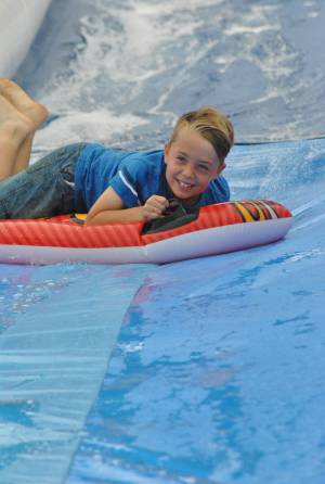Ilminster Town FC fun day Part 18 – July 9, 2016: A giant water slide was the star attraction at a family fun day held to celebrate Ilminster Town Football Club’s new Archie Gooch Pavilion headquarters in Britten’s Field. Photo 21
