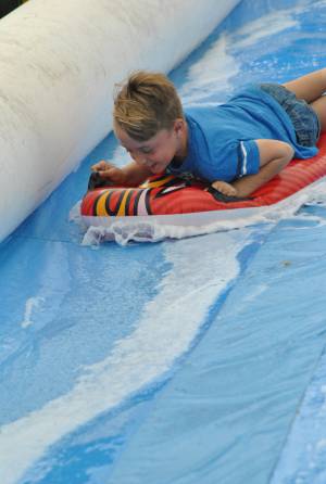 Ilminster Town FC fun day Part 18 – July 9, 2016: A giant water slide was the star attraction at a family fun day held to celebrate Ilminster Town Football Club’s new Archie Gooch Pavilion headquarters in Britten’s Field. Photo 22