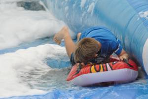 Ilminster Town FC fun day Part 18 – July 9, 2016: A giant water slide was the star attraction at a family fun day held to celebrate Ilminster Town Football Club’s new Archie Gooch Pavilion headquarters in Britten’s Field. Photo 25