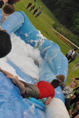 Ilminster Town FC fun day Part 19 – July 9, 2016: A giant water slide was the star attraction at a family fun day held to celebrate Ilminster Town Football Club’s new Archie Gooch Pavilion headquarters in Britten’s Field. Photo 1