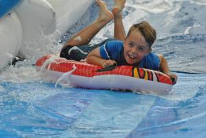 Ilminster Town FC fun day Part 19 – July 9, 2016: A giant water slide was the star attraction at a family fun day held to celebrate Ilminster Town Football Club’s new Archie Gooch Pavilion headquarters in Britten’s Field. Photo 25