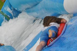 Ilminster Town FC fun day Part 20 – July 9, 2016: A giant water slide was the star attraction at a family fun day held to celebrate Ilminster Town Football Club’s new Archie Gooch Pavilion headquarters in Britten’s Field. Photo 27