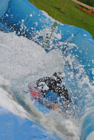 Ilminster Town FC fun day Part 20 – July 9, 2016: A giant water slide was the star attraction at a family fun day held to celebrate Ilminster Town Football Club’s new Archie Gooch Pavilion headquarters in Britten’s Field. Photo 4