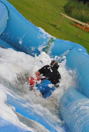 Ilminster Town FC fun day Part 20 – July 9, 2016: A giant water slide was the star attraction at a family fun day held to celebrate Ilminster Town Football Club’s new Archie Gooch Pavilion headquarters in Britten’s Field. Photo 5