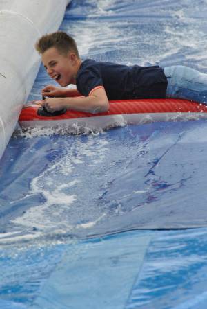 Ilminster Town FC fun day Part 20 – July 9, 2016: A giant water slide was the star attraction at a family fun day held to celebrate Ilminster Town Football Club’s new Archie Gooch Pavilion headquarters in Britten’s Field. Photo 7