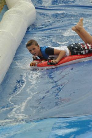 Ilminster Town FC fun day Part 22 – July 9, 2016: A giant water slide was the star attraction at a family fun day held to celebrate Ilminster Town Football Club’s new Archie Gooch Pavilion headquarters in Britten’s Field. Photo 15