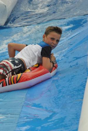 Ilminster Town FC fun day Part 22 – July 9, 2016: A giant water slide was the star attraction at a family fun day held to celebrate Ilminster Town Football Club’s new Archie Gooch Pavilion headquarters in Britten’s Field. Photo 16
