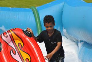 Ilminster Town FC fun day Part 23 – July 9, 2016: A giant water slide was the star attraction at a family fun day held to celebrate Ilminster Town Football Club’s new Archie Gooch Pavilion headquarters in Britten’s Field. Photo 17