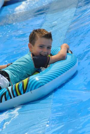 Ilminster Town FC fun day Part 23 – July 9, 2016: A giant water slide was the star attraction at a family fun day held to celebrate Ilminster Town Football Club’s new Archie Gooch Pavilion headquarters in Britten’s Field. Photo 6