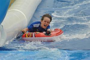 Ilminster Town FC fun day Part 25 – July 9, 2016: A giant water slide was the star attraction at a family fun day held to celebrate Ilminster Town Football Club’s new Archie Gooch Pavilion headquarters in Britten’s Field. Photo 16