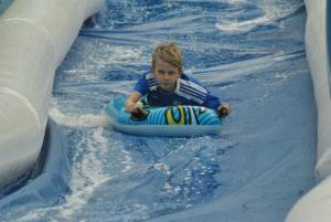 Ilminster Town FC fun day Part 26 – July 9, 2016: A giant water slide was the star attraction at a family fun day held to celebrate Ilminster Town Football Club’s new Archie Gooch Pavilion headquarters in Britten’s Field. Photo 16