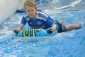 Ilminster Town FC fun day Part 26 – July 9, 2016: A giant water slide was the star attraction at a family fun day held to celebrate Ilminster Town Football Club’s new Archie Gooch Pavilion headquarters in Britten’s Field. Photo 18