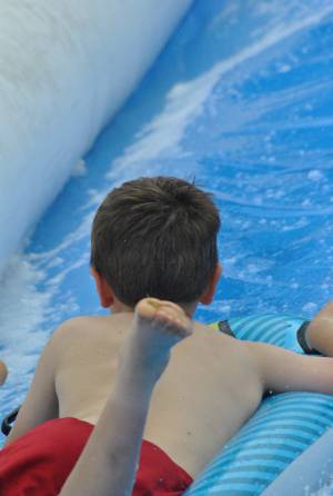 Ilminster Town FC fun day Part 27 – July 9, 2016: A giant water slide was the star attraction at a family fun day held to celebrate Ilminster Town Football Club’s new Archie Gooch Pavilion headquarters in Britten’s Field. Photo 1