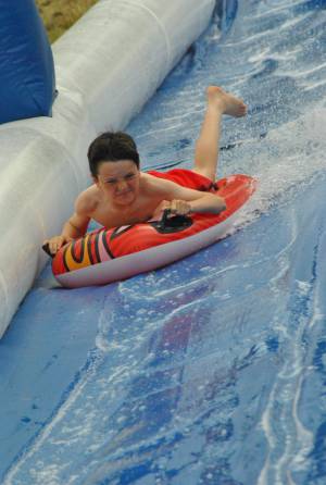 Ilminster Town FC fun day Part 27 – July 9, 2016: A giant water slide was the star attraction at a family fun day held to celebrate Ilminster Town Football Club’s new Archie Gooch Pavilion headquarters in Britten’s Field. Photo 19