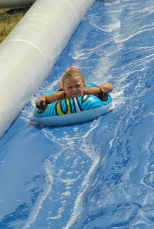 Ilminster Town FC fun day Part 27 – July 9, 2016: A giant water slide was the star attraction at a family fun day held to celebrate Ilminster Town Football Club’s new Archie Gooch Pavilion headquarters in Britten’s Field. Photo 29