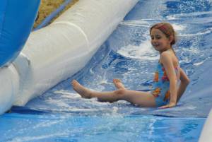 Ilminster Town FC fun day Part 27 – July 9, 2016: A giant water slide was the star attraction at a family fun day held to celebrate Ilminster Town Football Club’s new Archie Gooch Pavilion headquarters in Britten’s Field. Photo 7