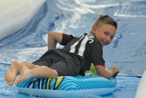Ilminster Town FC fun day Part 27 – July 9, 2016: A giant water slide was the star attraction at a family fun day held to celebrate Ilminster Town Football Club’s new Archie Gooch Pavilion headquarters in Britten’s Field. Photo 8