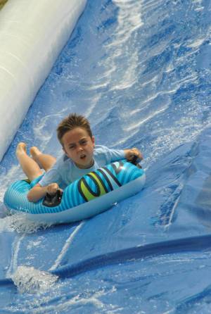 Ilminster Town FC fun day Part 28 – July 9, 2016: A giant water slide was the star attraction at a family fun day held to celebrate Ilminster Town Football Club’s new Archie Gooch Pavilion headquarters in Britten’s Field. Photo 10