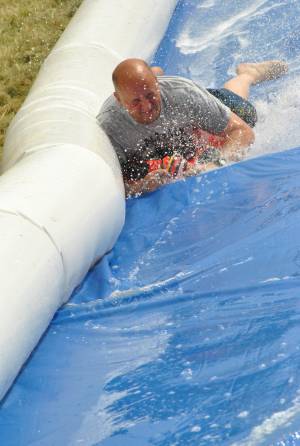 Ilminster Town FC fun day Part 28 – July 9, 2016: A giant water slide was the star attraction at a family fun day held to celebrate Ilminster Town Football Club’s new Archie Gooch Pavilion headquarters in Britten’s Field. Photo 13